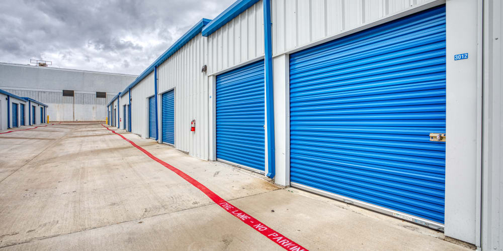 Large blue roll-up doors of our self storage units at Devon Self Storage in Fort Worth, Texas
