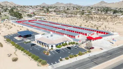 Exterior view of storage facility surrounded by mountains in West Apple Valley, CA, at Devon Self Storage - West Apple Valley