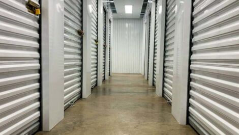 Clean and very well-lit indoor storage hallway at Devon Self Storage in Lynwood, Illinois