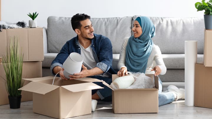 Man and woman packing storage boxes.