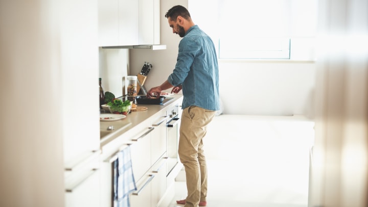 Man cooking in kitchen.