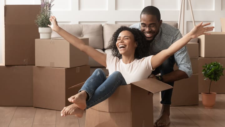 Man pushing women in storage box.