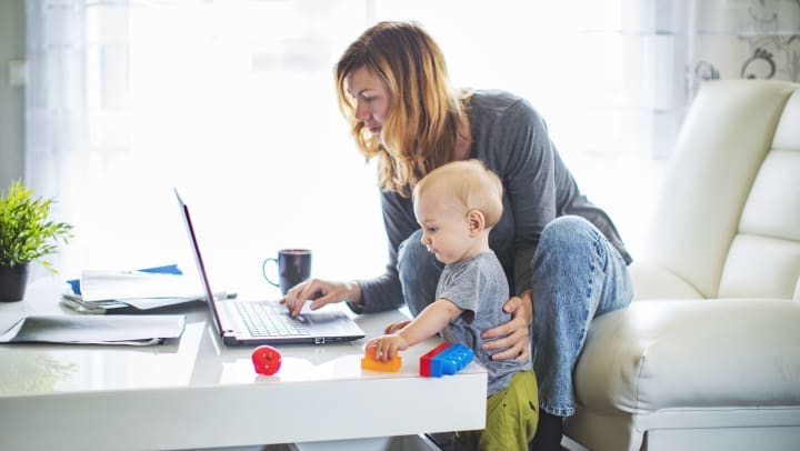 Woman and baby looking at laptop computer.