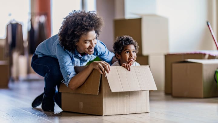 Woman and baby packing storage box.