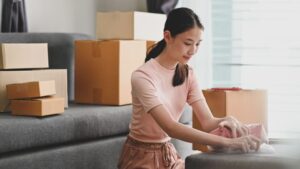 Woman packing storage box.