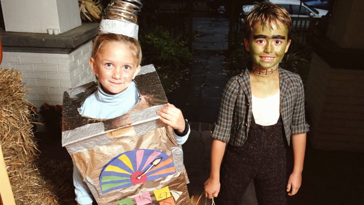 Boy and girl dressed in Halloween costumes.