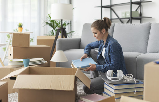 Happy young woman moving in her new apartment.