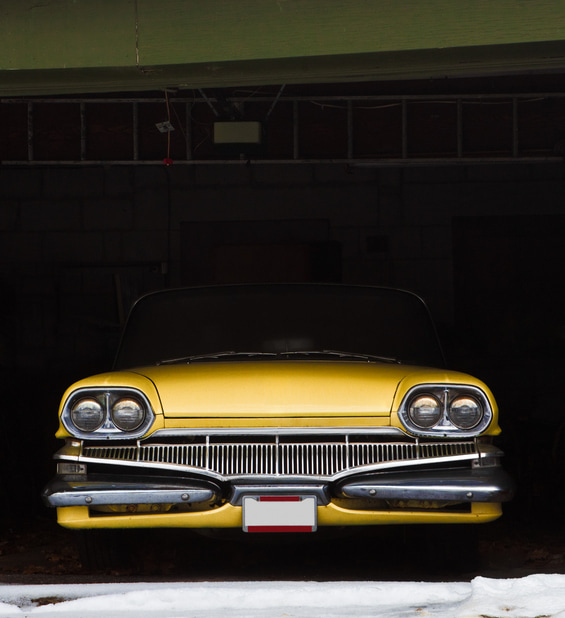 Yellow car inside a garage