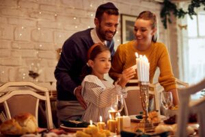 Family decorating dinner table for Hanukkah