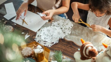 Family doing arts and crafts to decorate for the holiday season