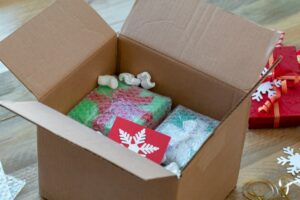 Cardboard box full of Christmas presents 