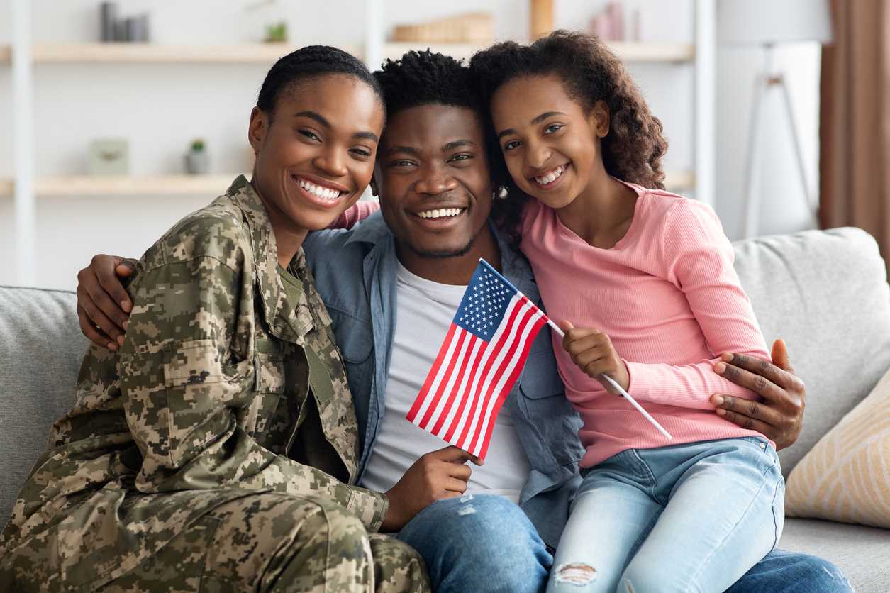 A military family smiling for the camera.