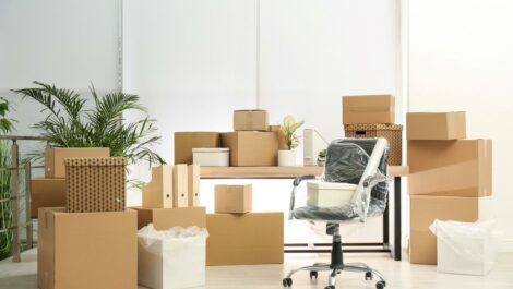 Cardboard boxes and packed chair in an office.