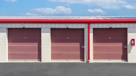 View of medium size storage units with red doors in Hendersonville at Devon Self Storage - Main Street