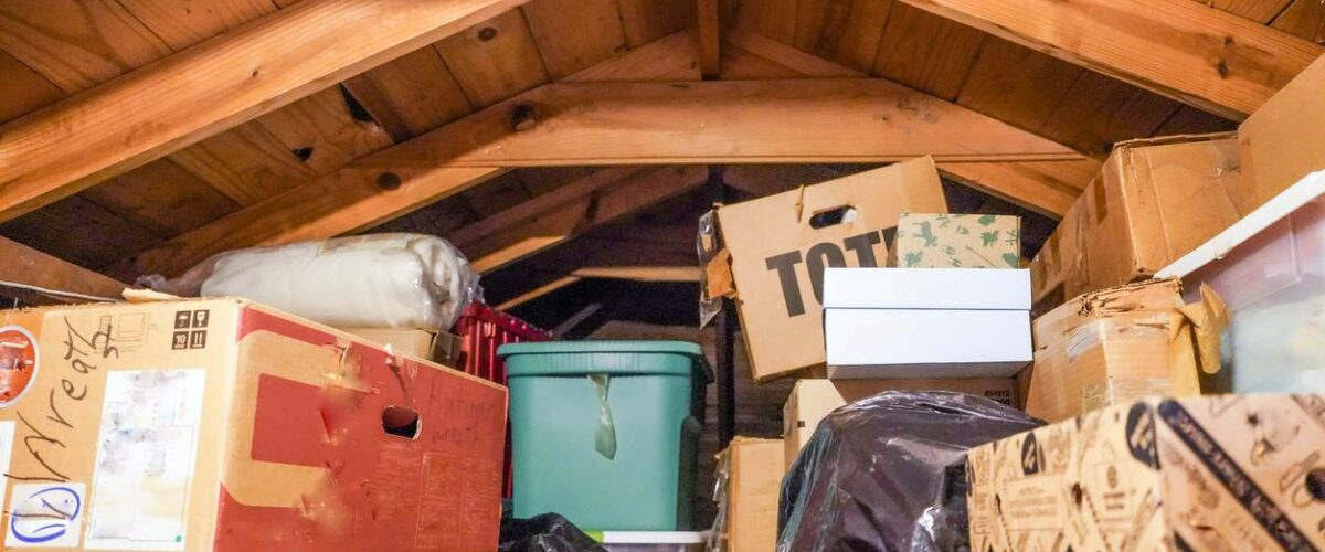 A disorganized attic above a residential garage.