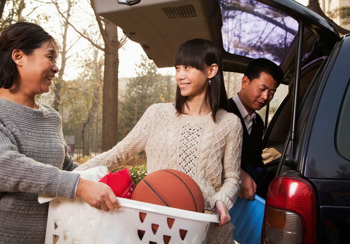 A college student and her parents load up their car to move back to college.