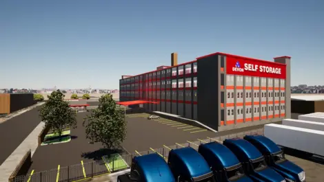 Self Storage Units in Philadelphia, PA, on Unruh Ave, future storage facility, view of parking lot, trees and building, glimpse of semi trucks