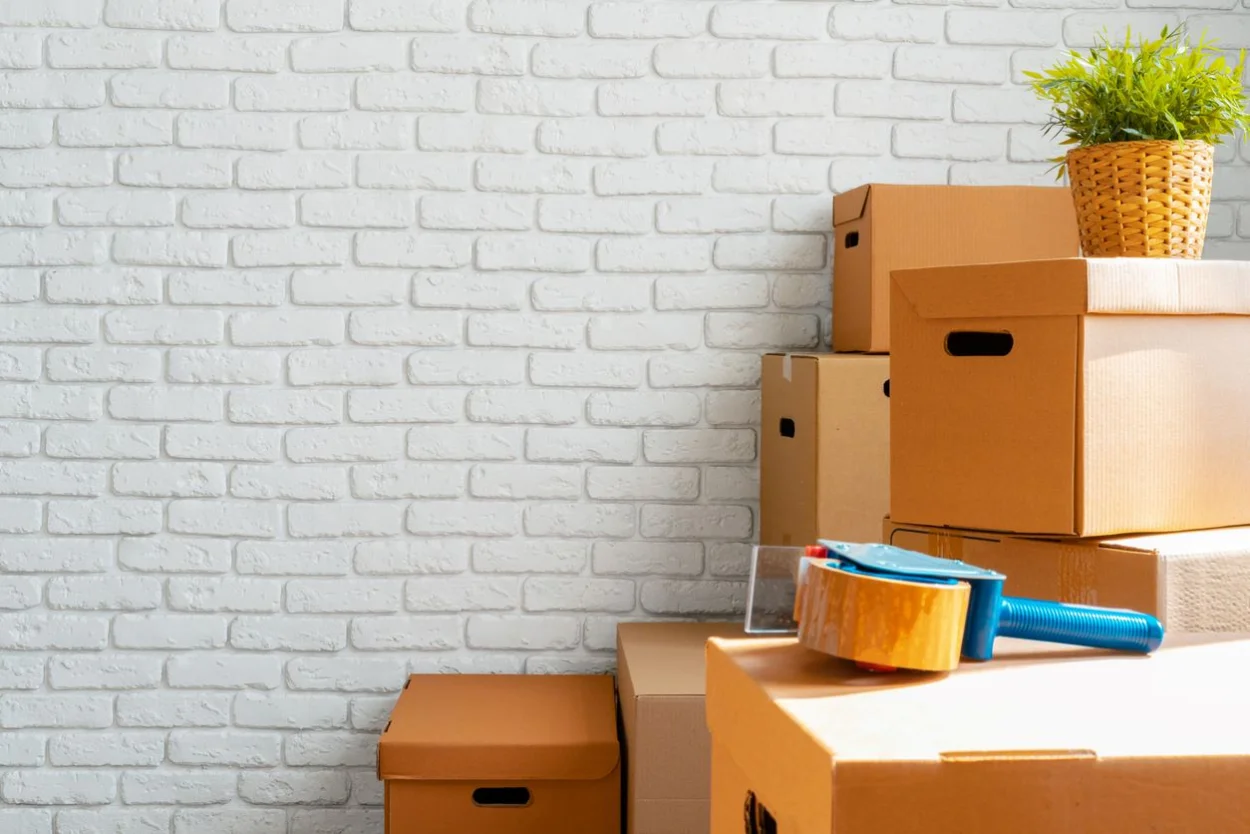 A close-up of moving boxes in an empty room.